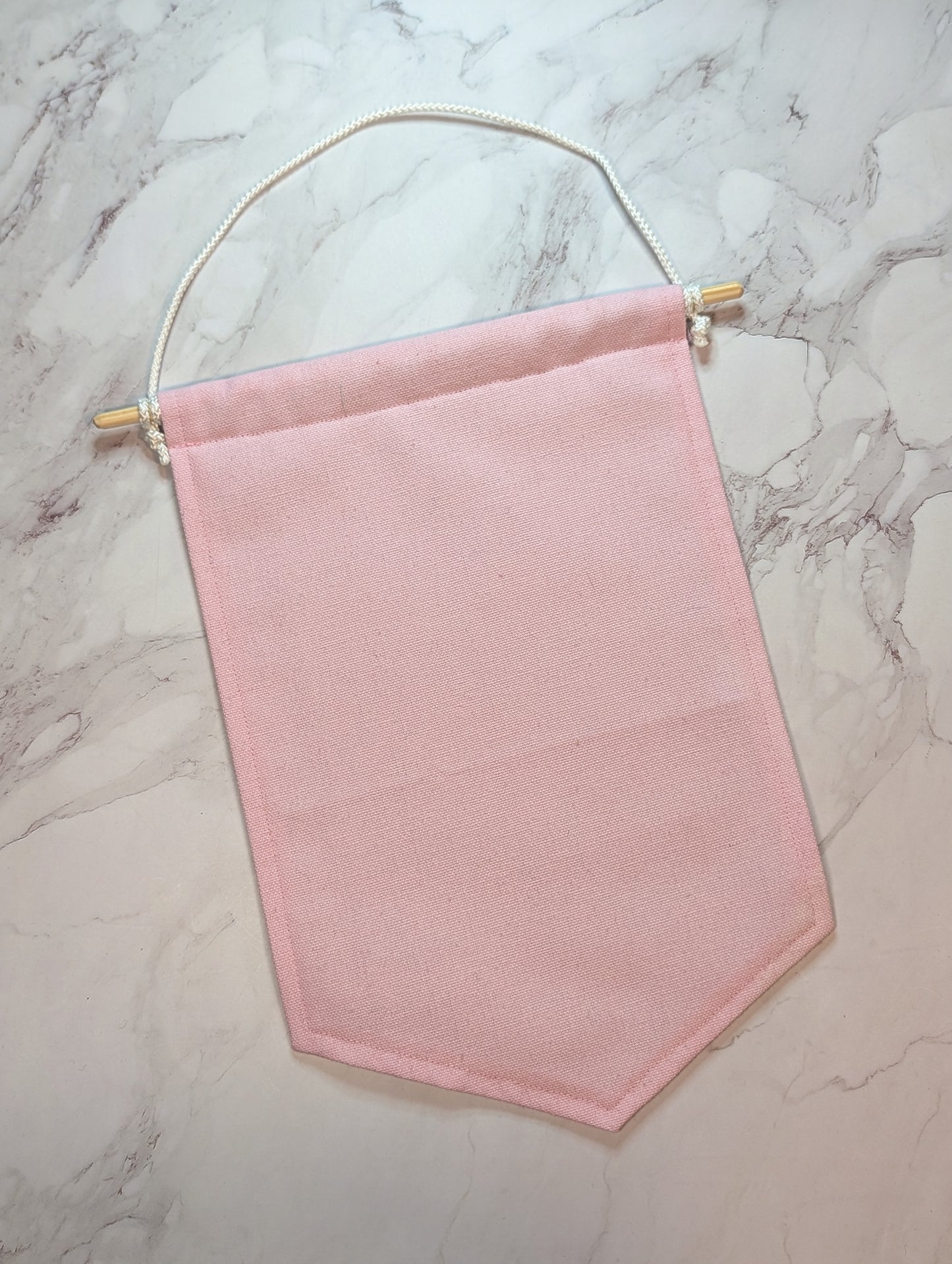 Pink fabric banner on a marble surface