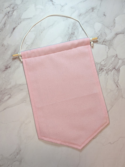 Pink fabric banner on a marble surface
