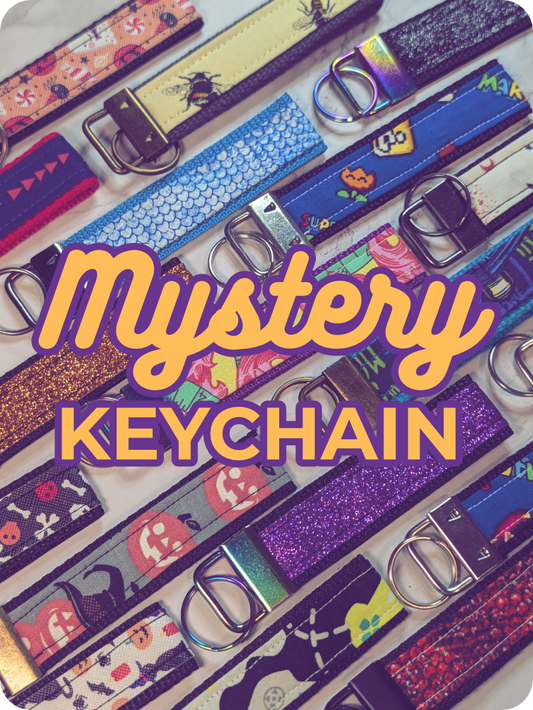 Colorful keychains with various designs on a white background, featuring the text 'Mystery Keychain'.