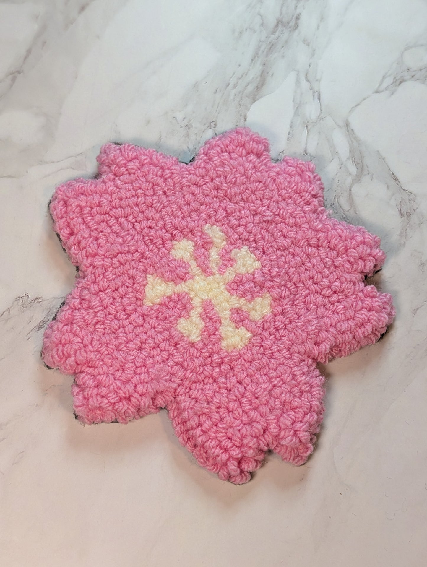 punch needle sakura mug rug on marble surface