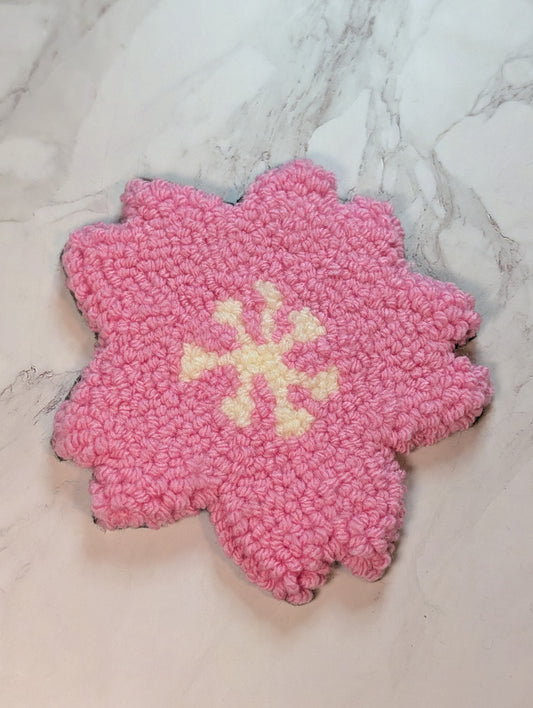 punch needle sakura mug rug on marble surface